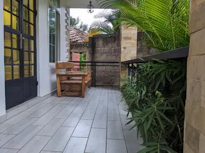 a patio with a bench and some plants at Mama Africa Killi Villa in Moshi