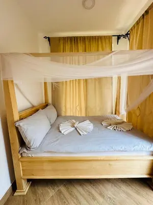 a bunk bed with two pillows on top of it at Golden hour tiny house in Arusha