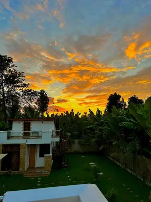a house with a sunset in the background at Golden hour tiny house in Arusha