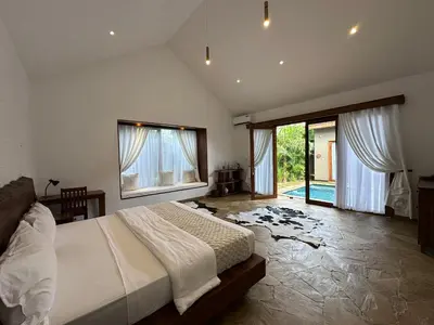 a bedroom with a bed and a large window at Tulivu Kilimanjaro Retreat in Moshi
