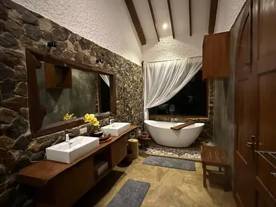 a bathroom with two sinks and a bath tub at Tulivu Kilimanjaro Retreat in Moshi