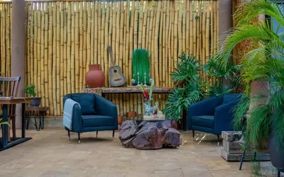 a lobby with two chairs and a table and a guitar at Tulivu Kilimanjaro Retreat in Moshi