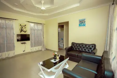 a living room with a couch and a table at BCB Homes in Moshi