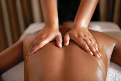 a woman with her hands on her back at Kilibase Hotel in Moshi