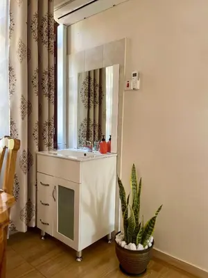 a bathroom with a sink and a mirror at NAURA HOMESTAYS in Arusha