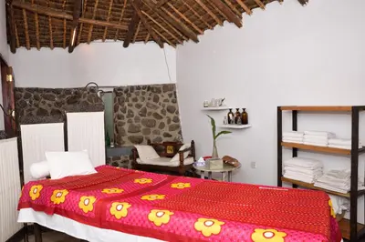 a bedroom with a bed with a red comforter at Kia Lodge in Arusha