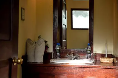 a bathroom with a sink and a mirror and towels at Kia Lodge in Arusha