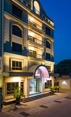 a tall building with an arch in front of it at Westwood Residences in Arusha