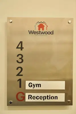 a sign on a door with a house on it at Westwood Residences in Arusha