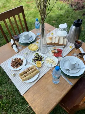 a picnic table with plates of food on it at Walk With Us Africa in Moshi
