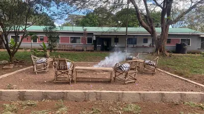 a group of chairs sitting around a fire pit at Walk With Us Africa in Moshi