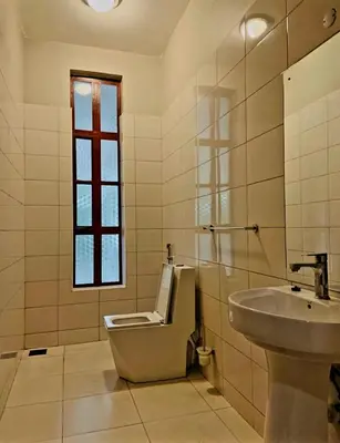 a bathroom with a toilet and a sink at Simba Villa in Arusha
