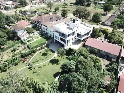 an aerial view of a large white house at Simba Villa in Arusha