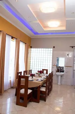 a dining room with a table and some chairs at Simba Villa in Arusha
