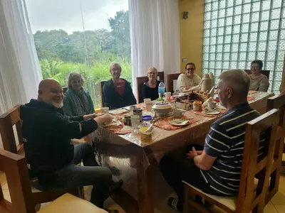 a group of people sitting around a table at Simba Villa in Arusha