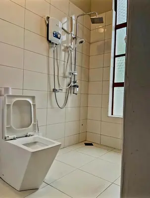 a bathroom with a shower and a toilet at Simba Villa in Arusha