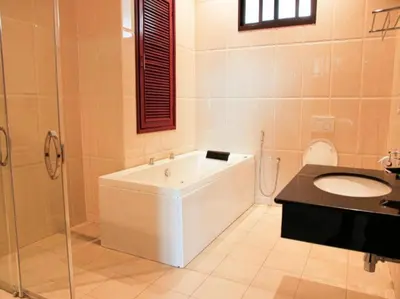 a bathroom with a tub and a sink and a toilet at Sanna Boutique Hotel in Arusha