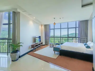 a large bedroom with a bed and a balcony at Sanna Boutique Hotel in Arusha