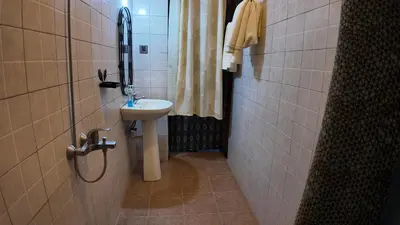 a small bathroom with a sink and a mirror at Korona Villa Lodge in Arusha