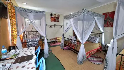 a bedroom with a bed with a canopy at Korona Villa Lodge in Arusha
