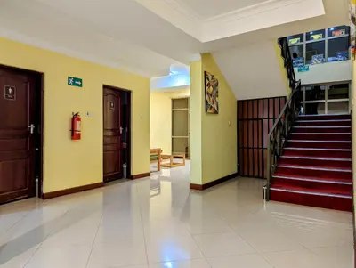 a hallway with a staircase in a building at Mvuli Hotels Arusha in Arusha