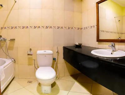 a bathroom with a toilet and a sink at Mvuli Hotels Arusha in Arusha