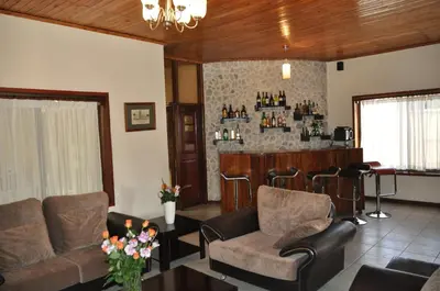 a living room with couches and a bar at The Milimani Lodge in Arusha
