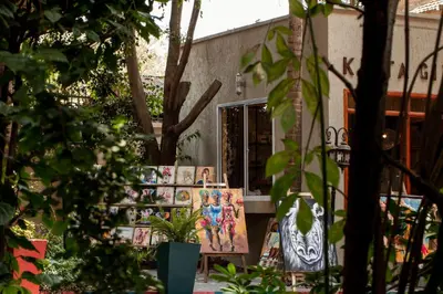 a shop with paintings on the side of a building at Tulia Boutique Hotel & Spa in Arusha