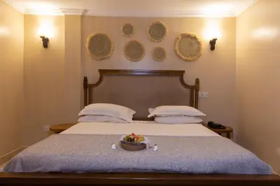 a bedroom with a bed with a basket of fruit on it at Tulia Boutique Hotel & Spa in Arusha