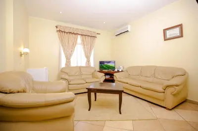 a living room with two chairs and a table at New Safari Hotel in Arusha