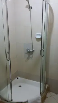 a shower with a glass door in a bathroom at Corridor Springs Hotel in Arusha