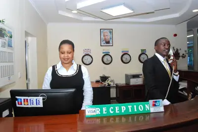 a woman sitting at a desk in an office at Corridor Springs Hotel in Arusha