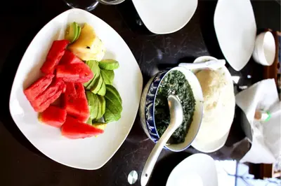 a plate of fruit and a bowl of pesto at Catherine home near kilimanjaro international airport JRO in Moshi
