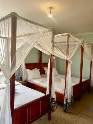 two bunk beds in a room withthritisthritisthritisthritisthritisthritisthritisthritisthritis at Patamu Restaurants Lodge & Safaris in Karatu