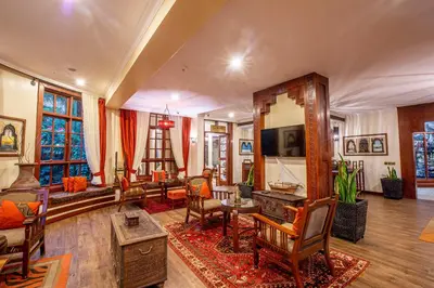 a living room with a couch and a table at African Tulip Hotel in Arusha