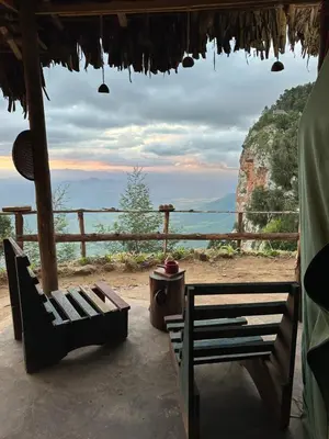 a porch with chairs and a view of the ocean at Uvi House & Restaurant in Mntindili