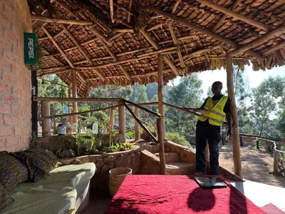 a man standing on a table in a house at Uvi House & Restaurant in Mntindili