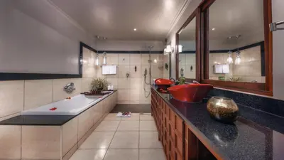 a large bathroom with a tub and a sink at Elewana Arusha Coffee Lodge in Arusha