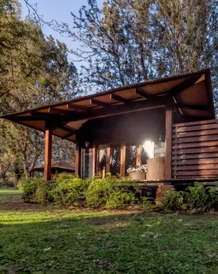 a pavilion in a park in the grass at Elewana Arusha Coffee Lodge in Arusha