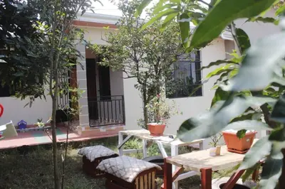 a patio with two tables and chairs in front of a house at Tamaduni Homestay & Lodge in Arusha