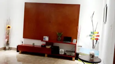 a living room with a table and a wall at Tamaduni Homestay & Lodge in Arusha