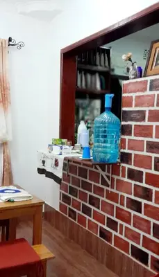 a brick wall with a blue bottle on top of it at Tamaduni Homestay & Lodge in Arusha