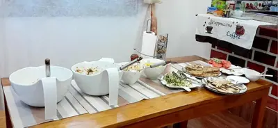 a table with bowls and plates of food on it at Tamaduni Homestay & Lodge in Arusha
