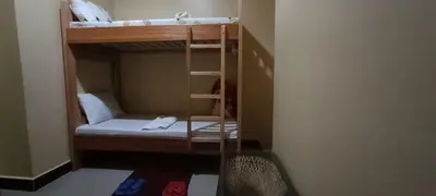 a couple of bunk beds in a room at Kilimanjaro Budget Lodge in Msaranga