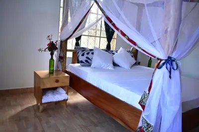 a bedroom with a bed with a canopy at Kili Kivuli in Msaranga