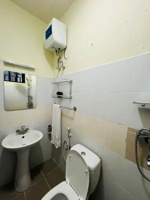 a bathroom with a toilet and a sink at Logic Stays 2 Bedroom Arusha City Centre in Arusha