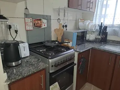 a kitchen with a stove and a counter top at Logic Stays 2 Bedroom Arusha City Centre in Arusha