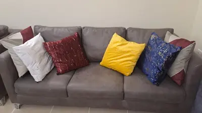 a bunch of pillows sitting on a couch at Logic Stays 2 Bedroom Arusha City Centre in Arusha