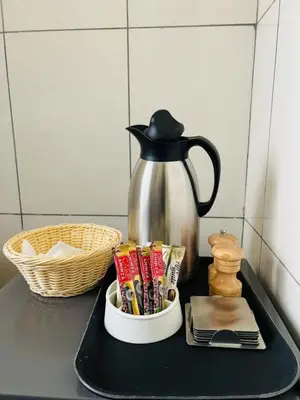 a tray with a tea kettle and snacks on a counter at Logic Stays 2 Bedroom Arusha City Centre in Arusha