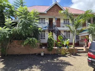 a house with a staircase in front of it at Seven Seven B&B in Arusha
